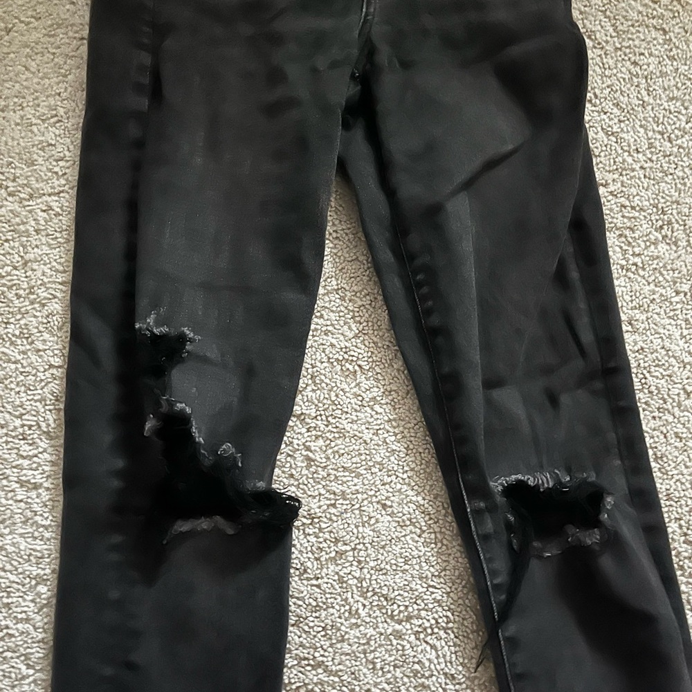 Black ripped at the knee jeans from American Eagle.